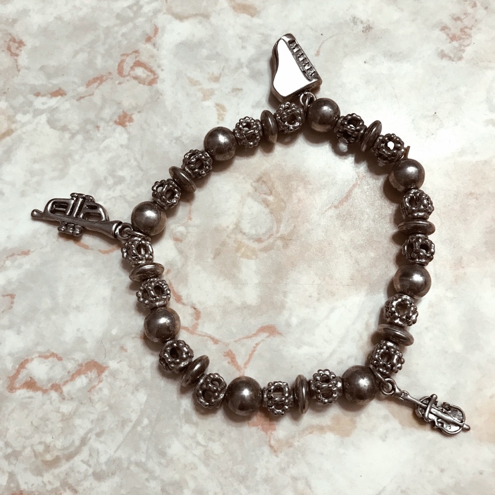 Silver bracelet with instrument charms